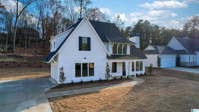 modern inspired farmhouse with a porch and a front yard