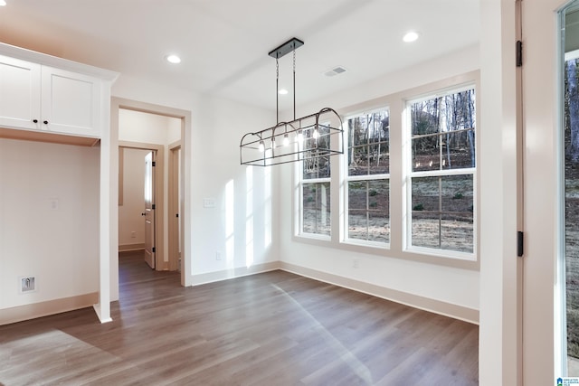 unfurnished dining area featuring hardwood / wood-style flooring