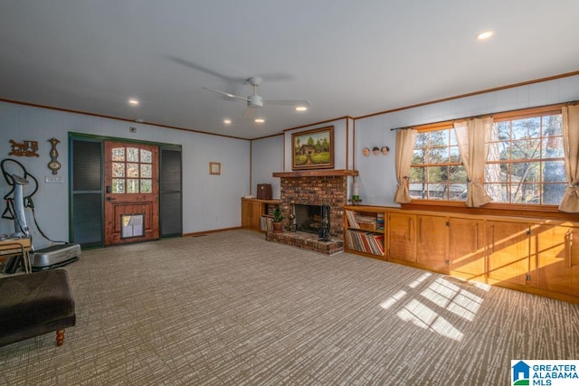 carpeted living room with a brick fireplace, ceiling fan, and ornamental molding