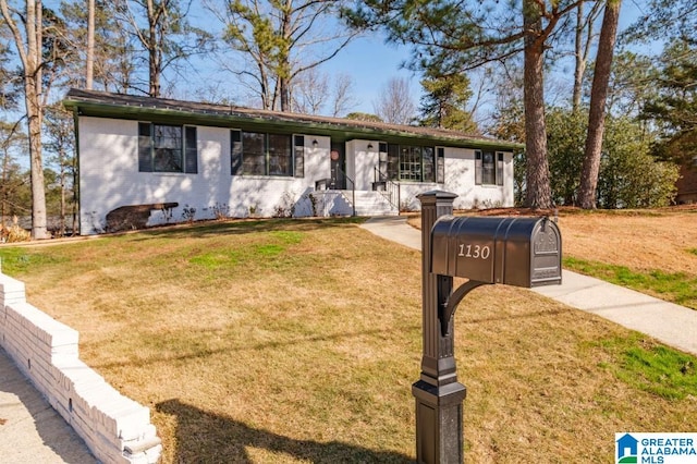 ranch-style home featuring a front yard