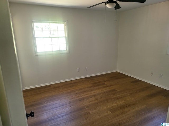 spare room featuring ceiling fan and dark hardwood / wood-style flooring