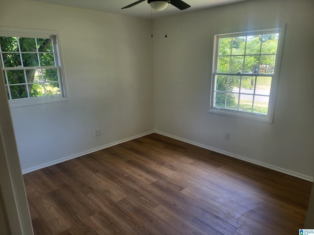 spare room with ceiling fan, dark hardwood / wood-style flooring, and plenty of natural light