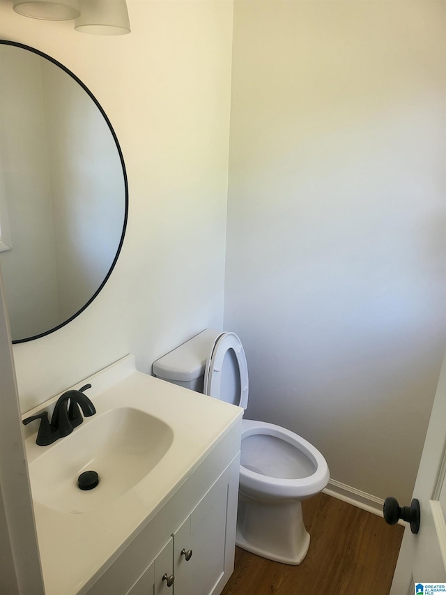 bathroom featuring hardwood / wood-style floors, vanity, and toilet