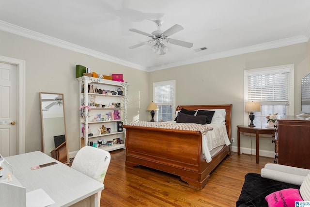 bedroom featuring ceiling fan, crown molding, and hardwood / wood-style floors