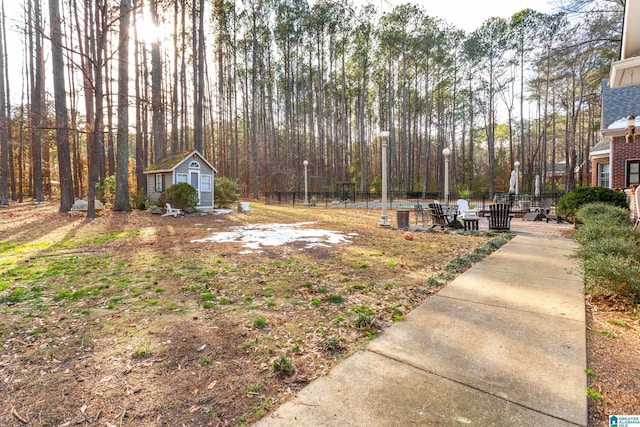 view of yard with a storage unit and a patio area