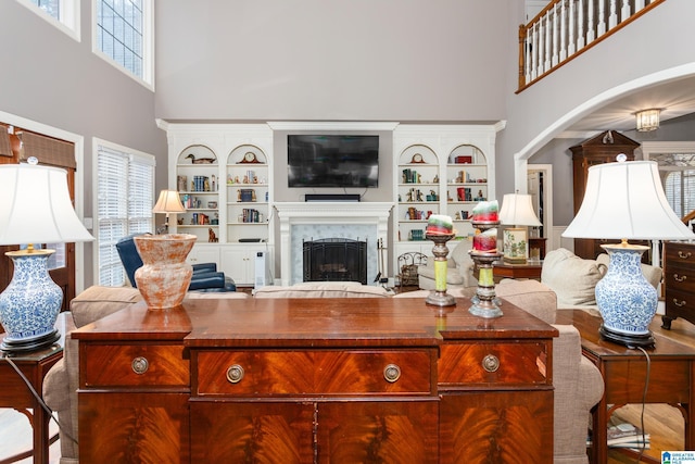 living room with a high ceiling and plenty of natural light