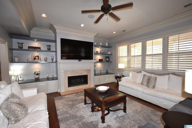 living room with ceiling fan, a premium fireplace, ornamental molding, and hardwood / wood-style flooring