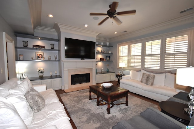 living room featuring ceiling fan, hardwood / wood-style floors, and crown molding