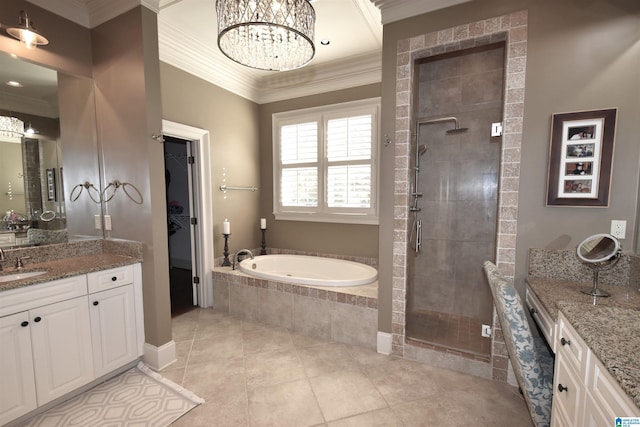 bathroom with tile patterned flooring, an inviting chandelier, ornamental molding, plus walk in shower, and vanity