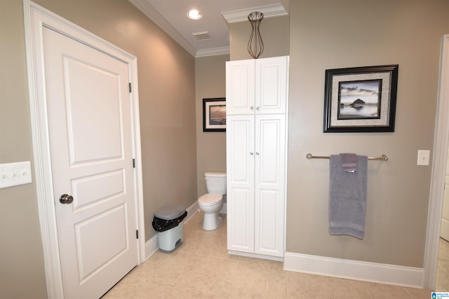 bathroom featuring tile patterned flooring, crown molding, and toilet