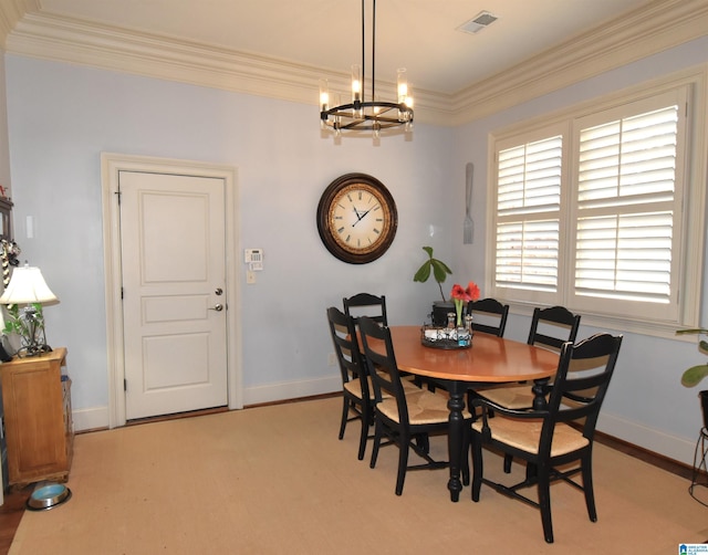 dining room with crown molding and a notable chandelier