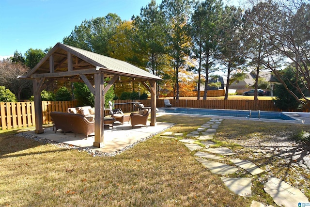 view of yard featuring a gazebo, a patio area, a covered pool, and an outdoor hangout area