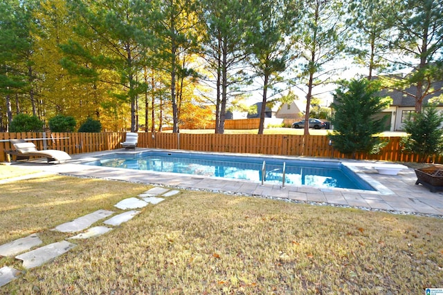 view of pool featuring a diving board, a yard, and a patio area