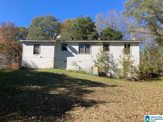 back of property featuring a lawn