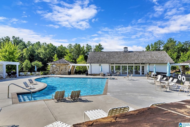 view of swimming pool featuring a pergola and a patio