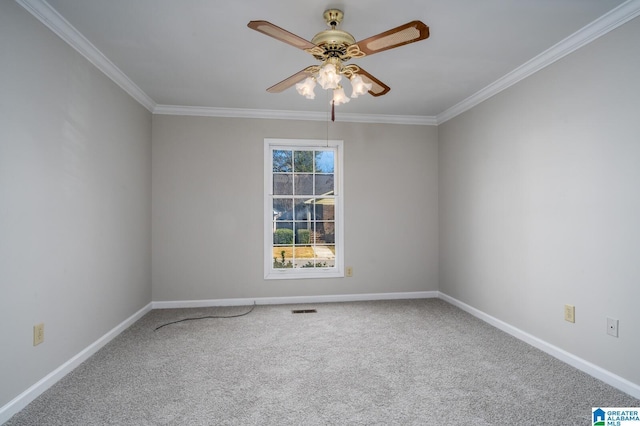 spare room with ceiling fan, carpet, and crown molding