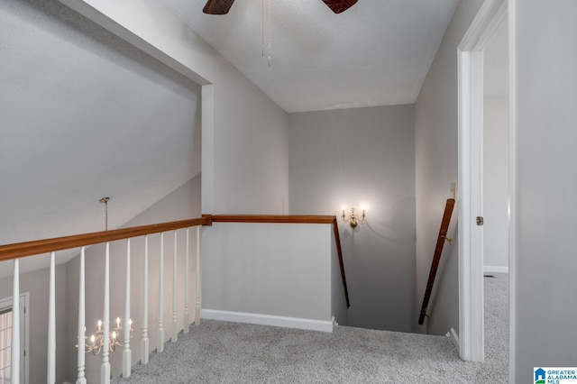 staircase featuring ceiling fan and carpet flooring