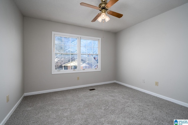 unfurnished room with ceiling fan and carpet flooring