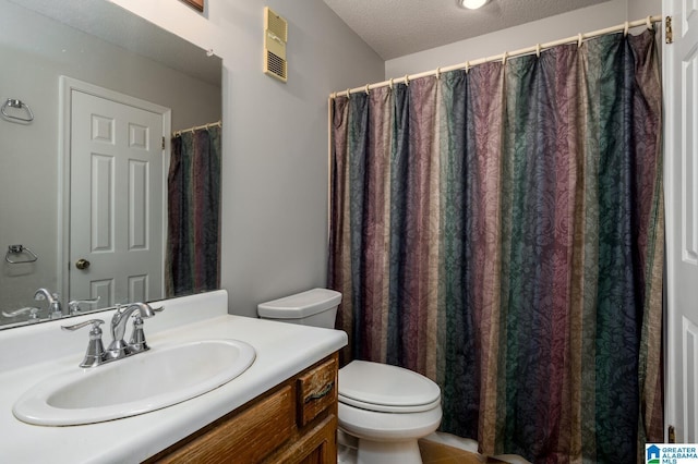 bathroom with a textured ceiling, toilet, and vanity