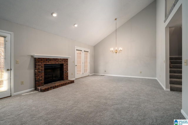 unfurnished living room featuring high vaulted ceiling, a fireplace, and carpet floors