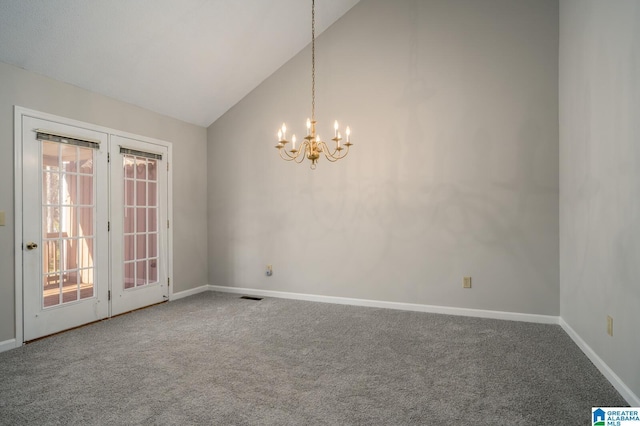 carpeted spare room with an inviting chandelier and vaulted ceiling