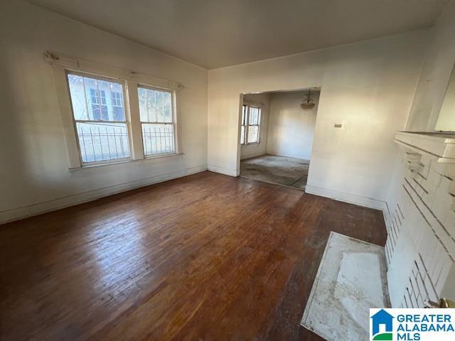 unfurnished living room featuring dark wood-type flooring