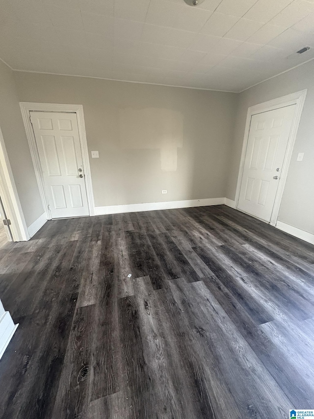 spare room featuring dark hardwood / wood-style flooring