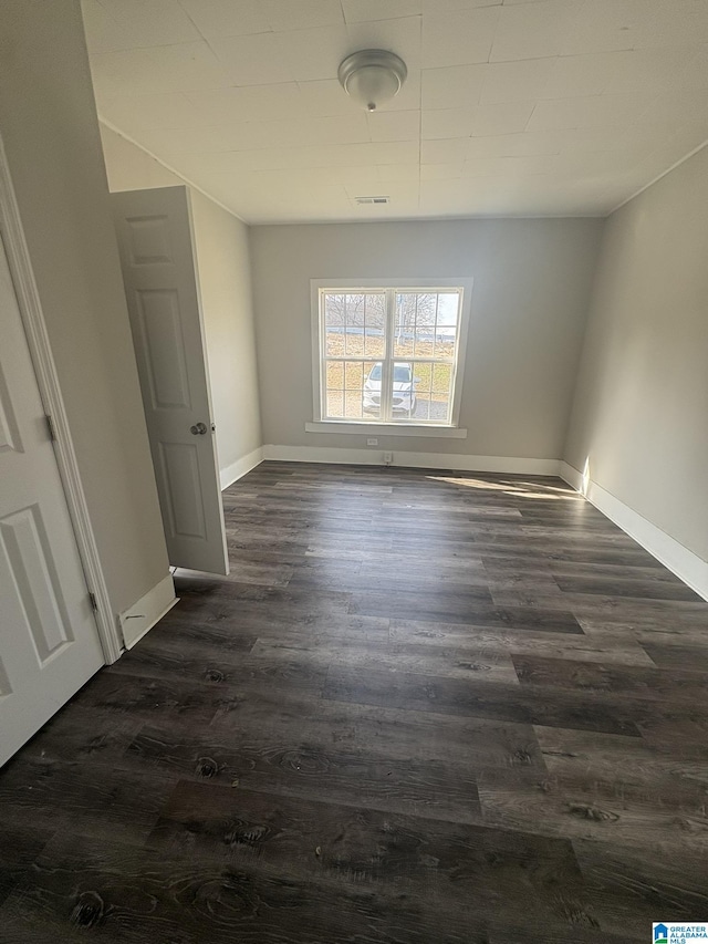 spare room featuring dark hardwood / wood-style floors