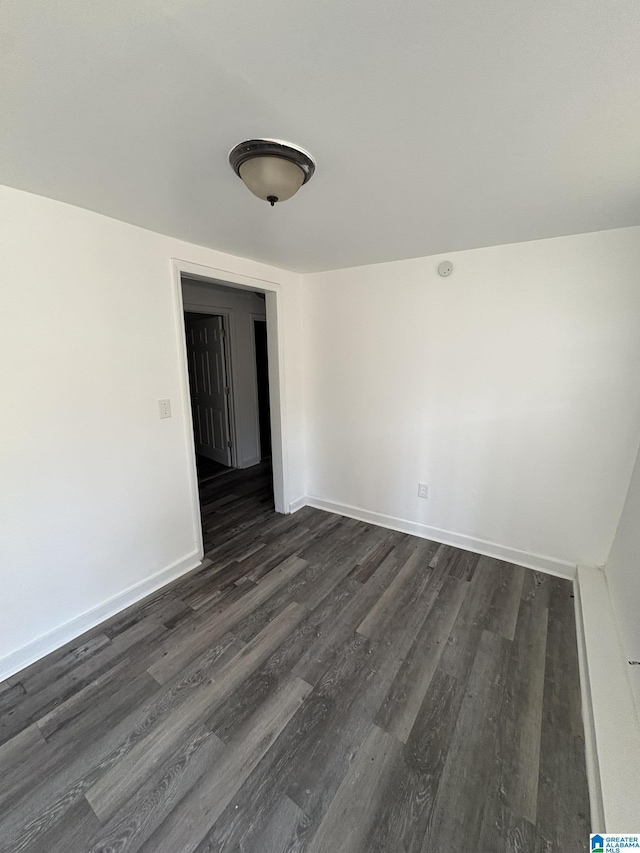 unfurnished room with dark hardwood / wood-style floors