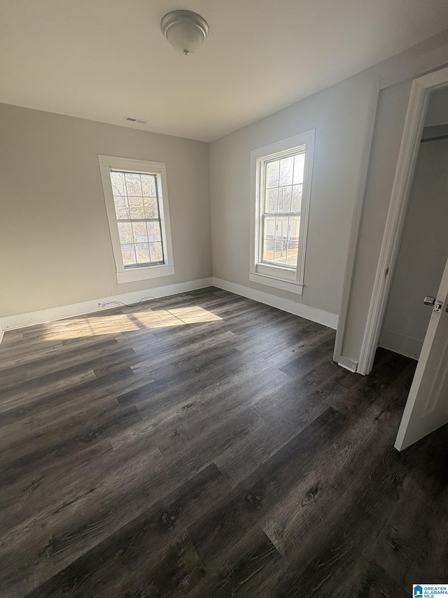 unfurnished bedroom featuring dark hardwood / wood-style flooring