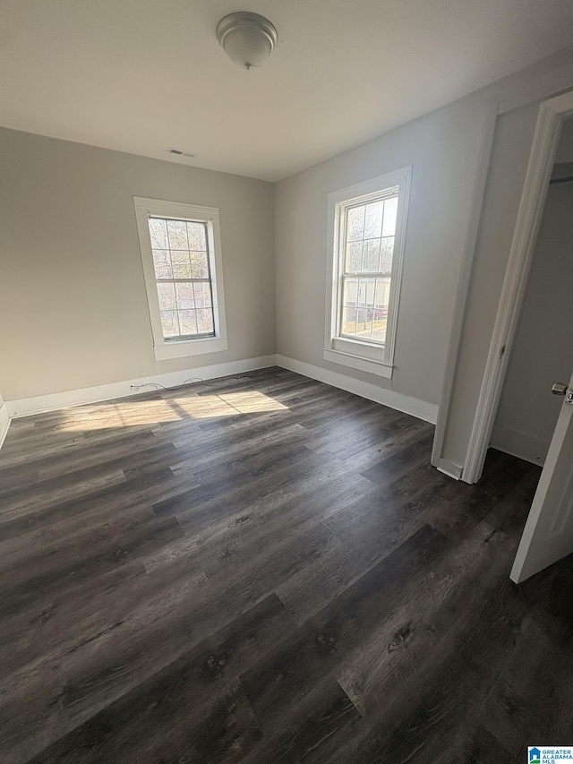 unfurnished bedroom featuring dark hardwood / wood-style flooring