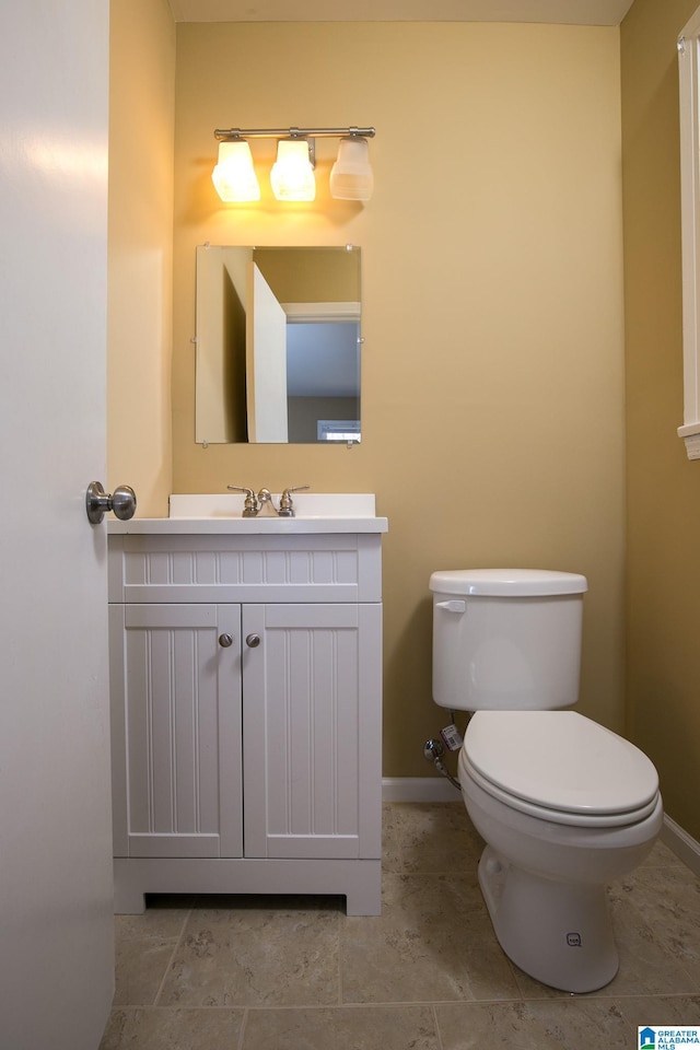 bathroom featuring toilet and vanity