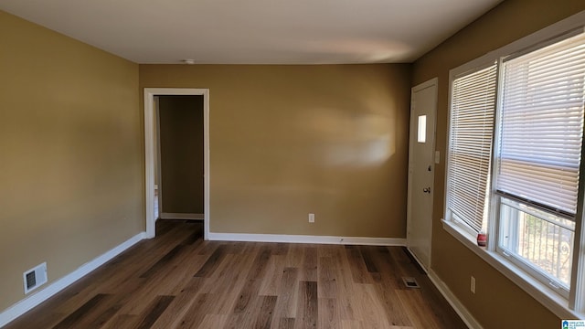 unfurnished room featuring dark hardwood / wood-style flooring