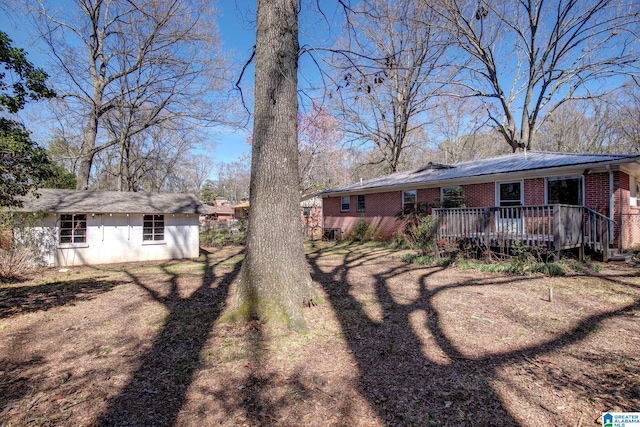 view of yard with a deck and an outbuilding