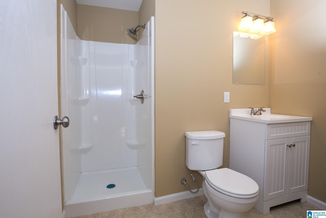 bathroom featuring toilet, walk in shower, and vanity