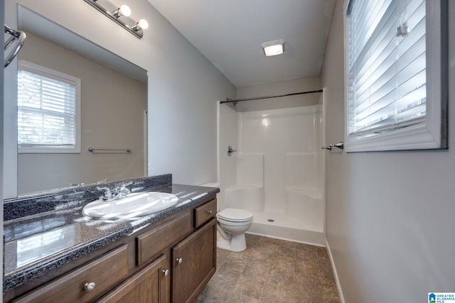 bathroom with toilet, walk in shower, and vanity