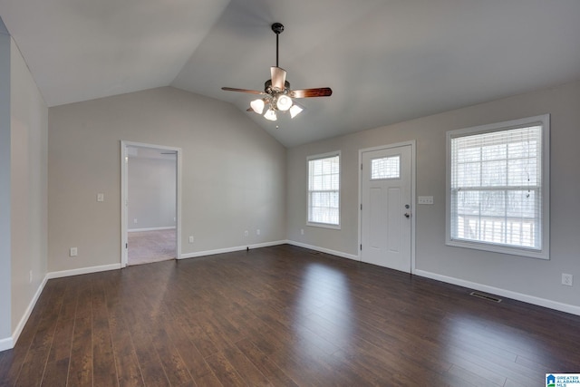 interior space featuring ceiling fan, dark wood-type flooring, and vaulted ceiling