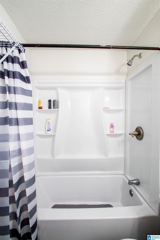 bathroom featuring a textured ceiling and shower / bath combo with shower curtain