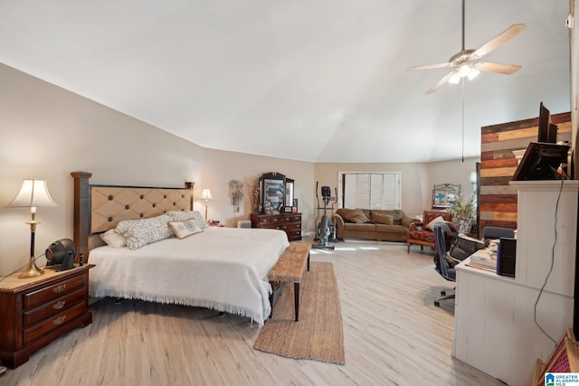 bedroom featuring ceiling fan, light hardwood / wood-style floors, and vaulted ceiling