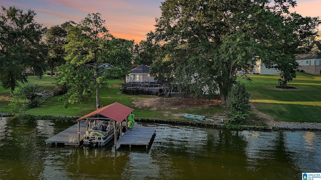 dock area with a water view and a lawn