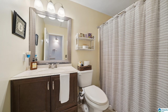 bathroom featuring toilet and vanity