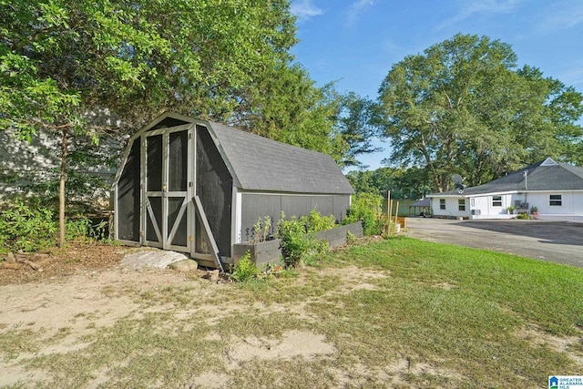 view of outbuilding with a lawn