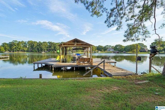 dock area featuring a water view and a lawn