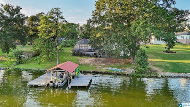 dock area with a water view and a lawn