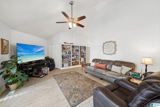 living room featuring ceiling fan, light wood-type flooring, and lofted ceiling