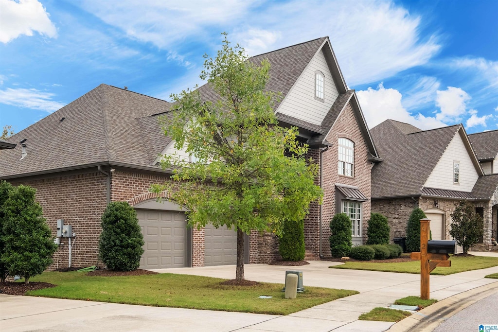 front of property featuring a front yard and a garage