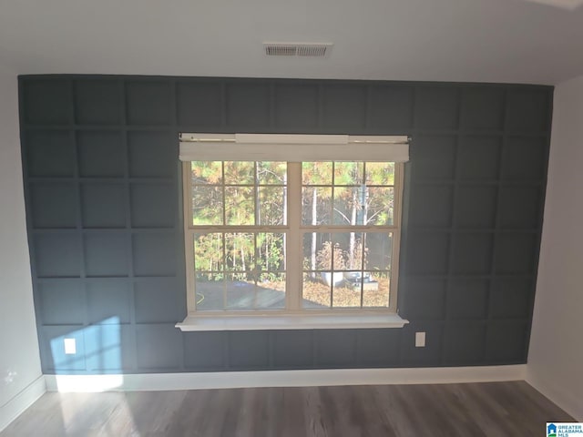 unfurnished room with hardwood / wood-style flooring