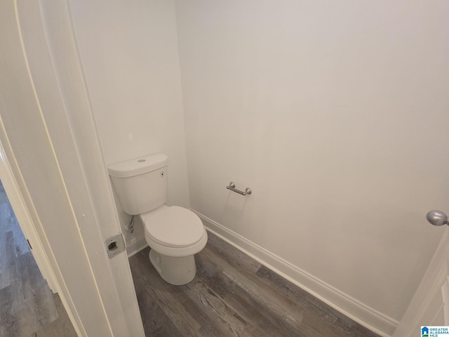 bathroom with toilet and hardwood / wood-style floors