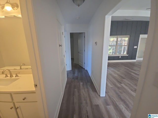 hallway featuring dark hardwood / wood-style flooring and sink