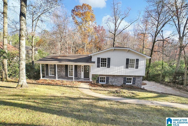 split level home featuring covered porch and a front lawn